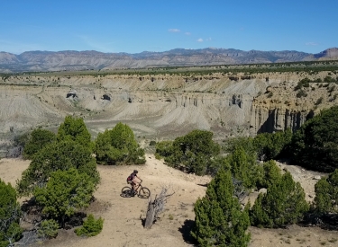 View north as Bruce rides the mesa edge on Lukes.